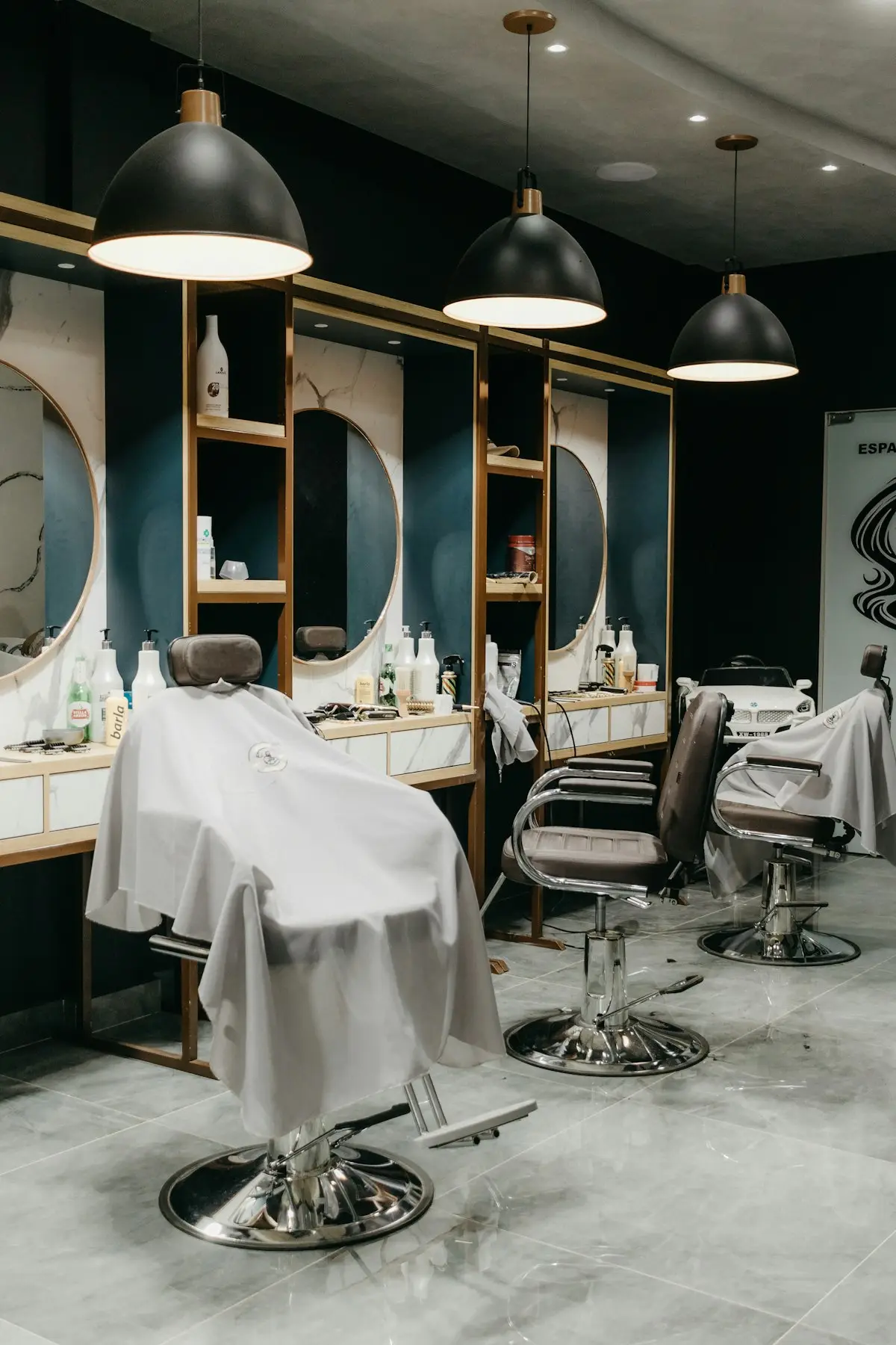 Ruang barbershop dengan kursi barber menghadap cermin